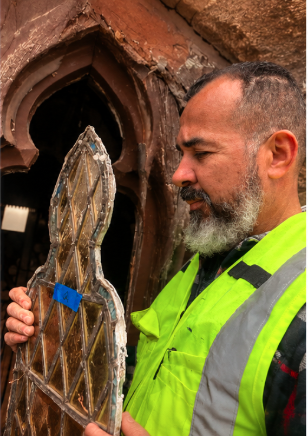 Craftsman restoring a stained glass panel
