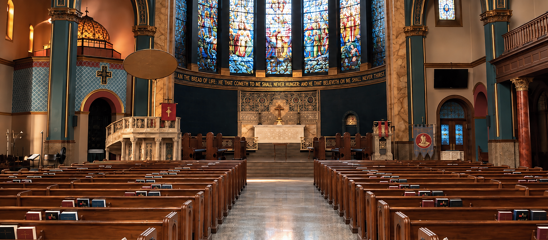 Gothic church nave with restored stained glass windows